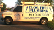 White Clog Free Plumbing van with the company name, slogan and phone number 404-446-8069 on the side